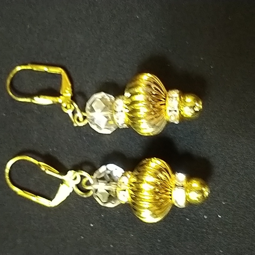 Handmade gold earrings with crystal accent.